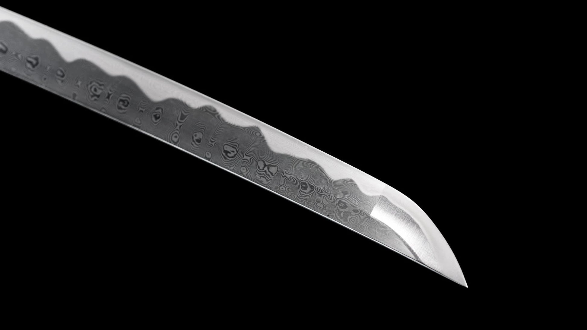 Sharp kissaki tip of the folded 1095 steel nodachi, showing the hamon and hada near the point.