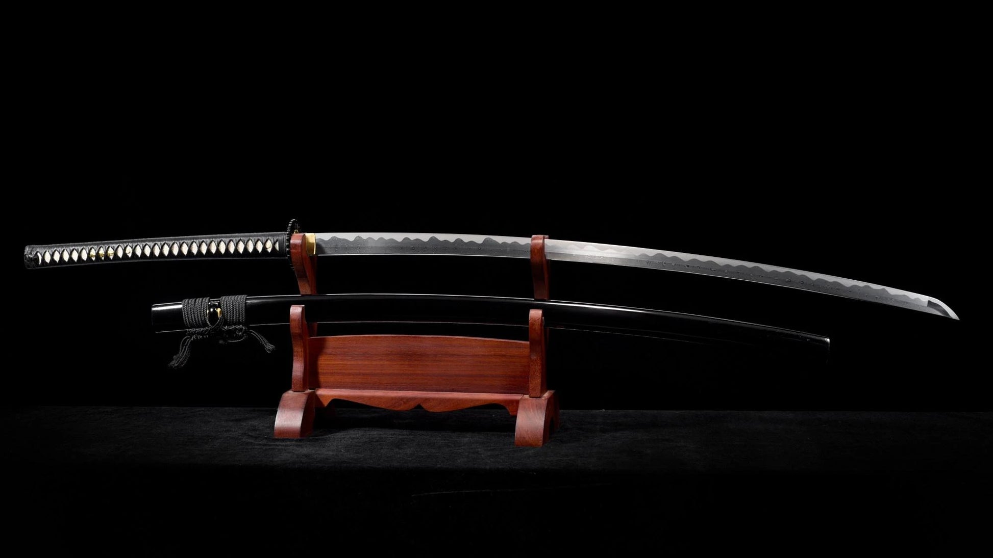 The 53-inch nodachi displayed on a wooden stand, blade above its black lacquer saya — full view.