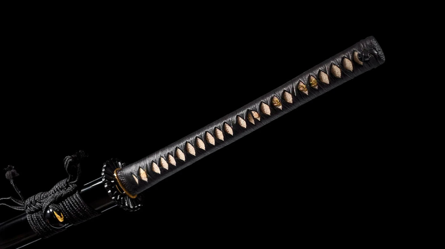 Black ito-wrapped tsuka over white rayskin with gold chrysanthemum menuki on the nodachi handle.