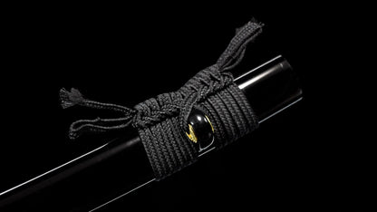Close-up of the black lacquer saya's kurikata and woven black sageo cord.