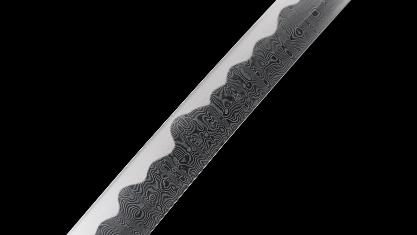 Detailed close-up of the wood-grain folded steel hada and notare hamon on the nodachi blade.