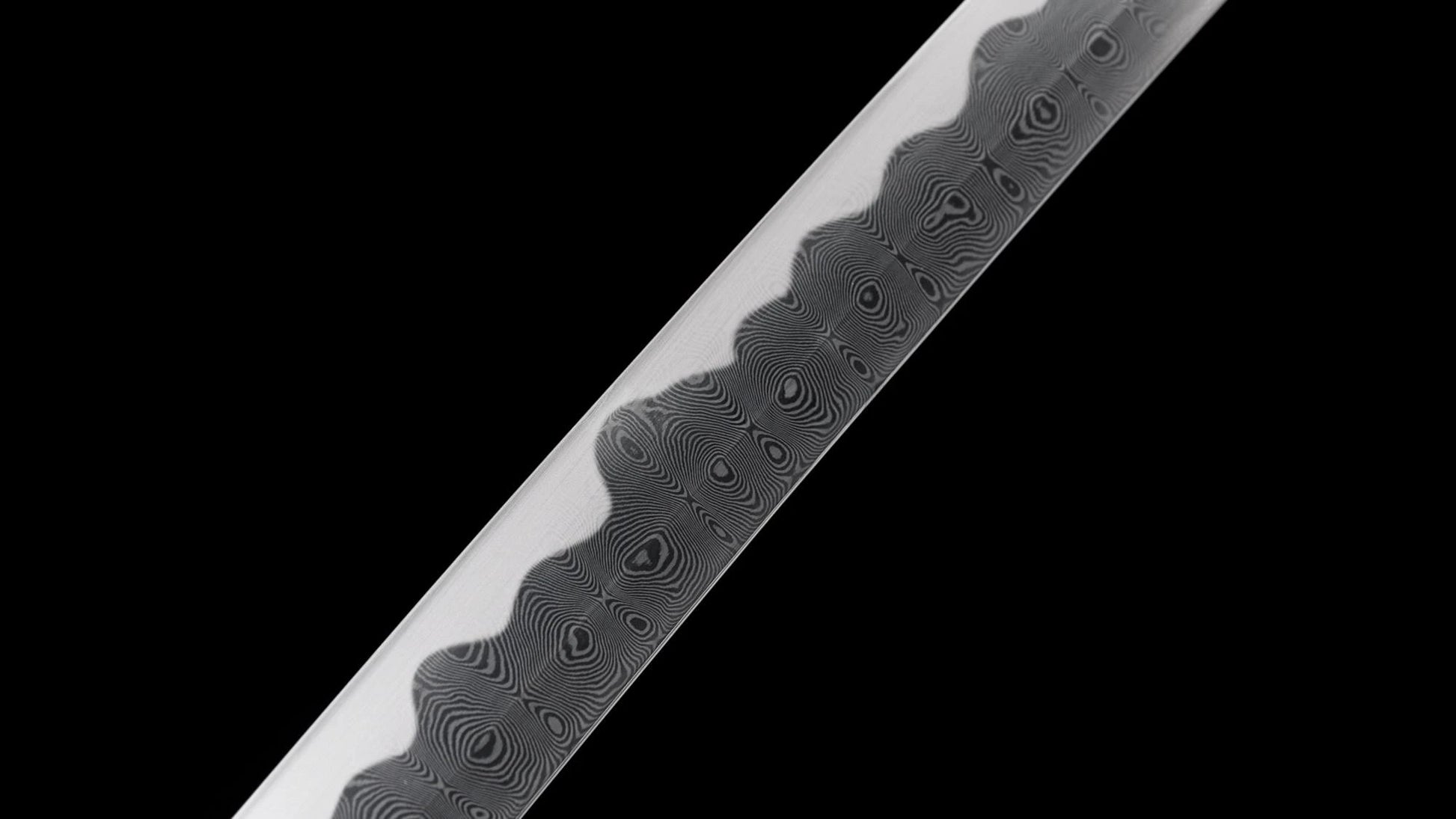 Detailed close-up of the wood-grain folded steel hada and notare hamon on the nodachi blade.