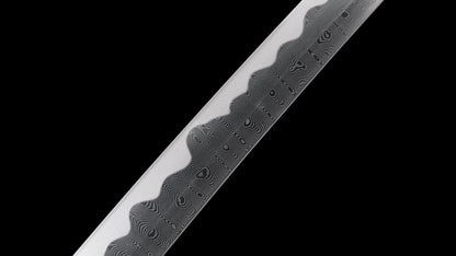 Detailed close-up of the wood-grain folded steel hada and notare hamon on the nodachi blade.