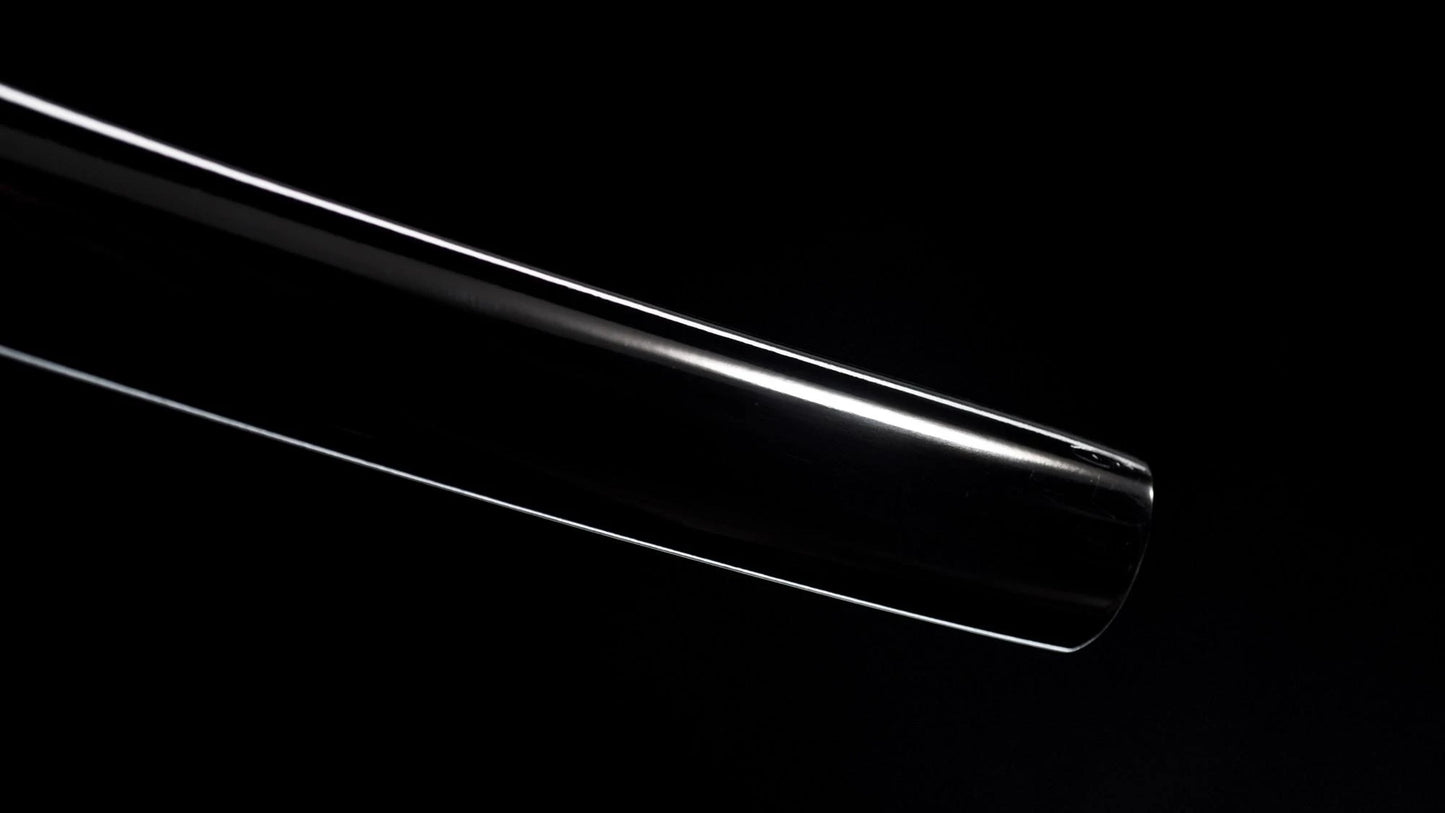 Polished folded-steel nodachi blade with a deep curve against a black background.