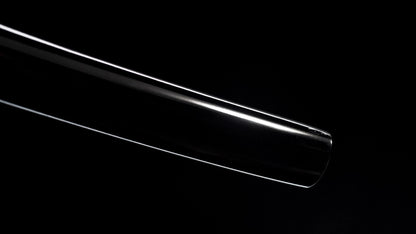 Polished folded-steel nodachi blade with a deep curve against a black background.