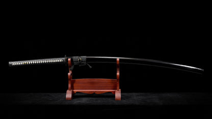 Full view of the sheathed nodachi on a display stand, showing the deep curve of the black saya.