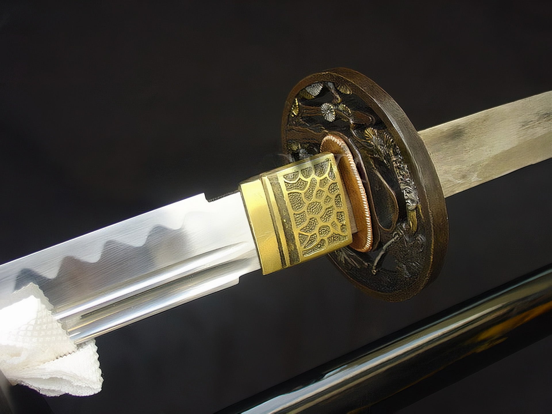 The Sage's Journey Katana partially drawn, revealing the 1095 steel blade and brass habaki.