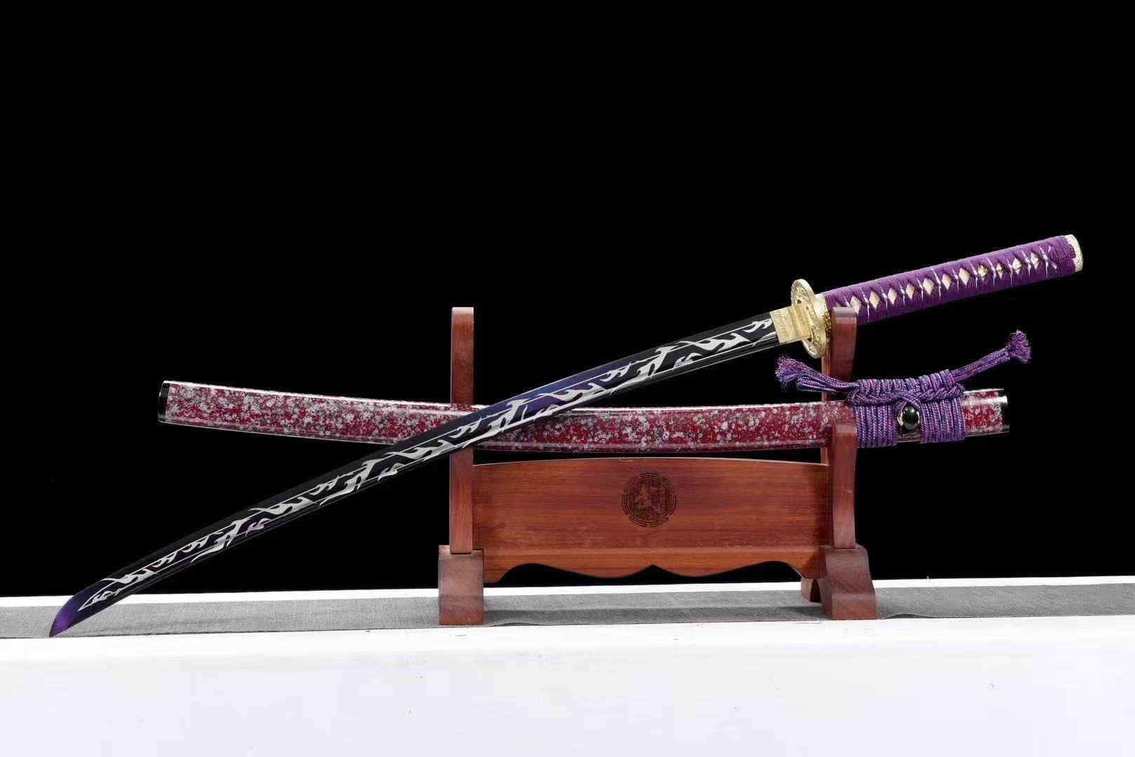 The Amethyst Flame Katana with its purple electroplated T10 steel blade, crossed over its speckled saya.