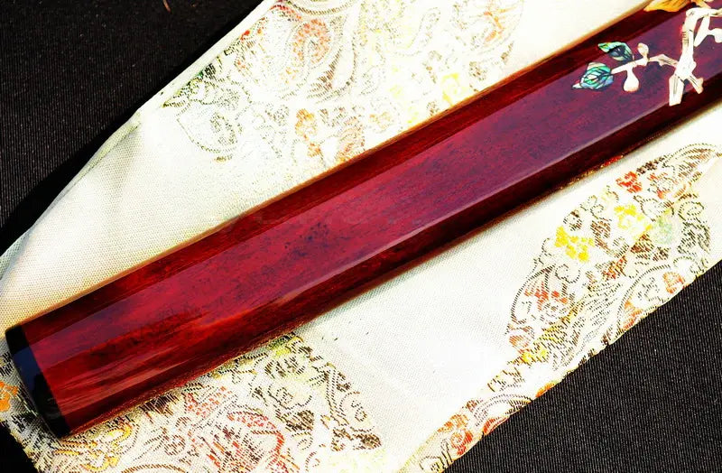 The Raden Ryū Katana's mother-of-pearl inlay saya displayed alongside its included silk sword bag.