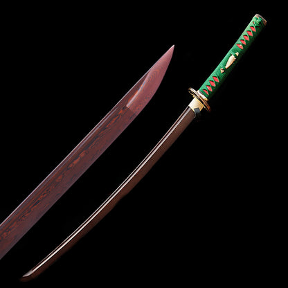 A composite image showing a full view of the unsheathed Nishikigoi Katana and a macro close-up of the red & black folded steel blade tip.
