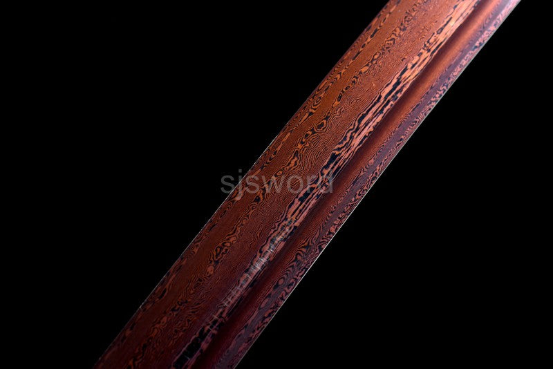 A macro shot of the red and black folded steel blade, showing the bo-hi (groove) and unique steel pattern.