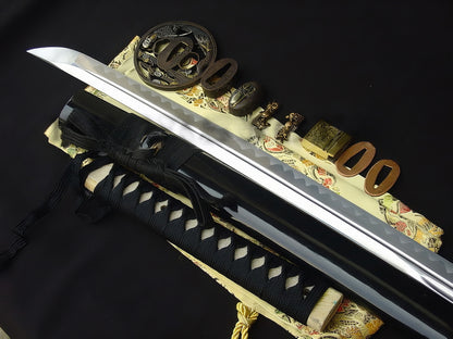 An alternate angle of the tsuka and tsuba, highlighting the "Sage's Journey" theme on the gilded and silvered brass.
