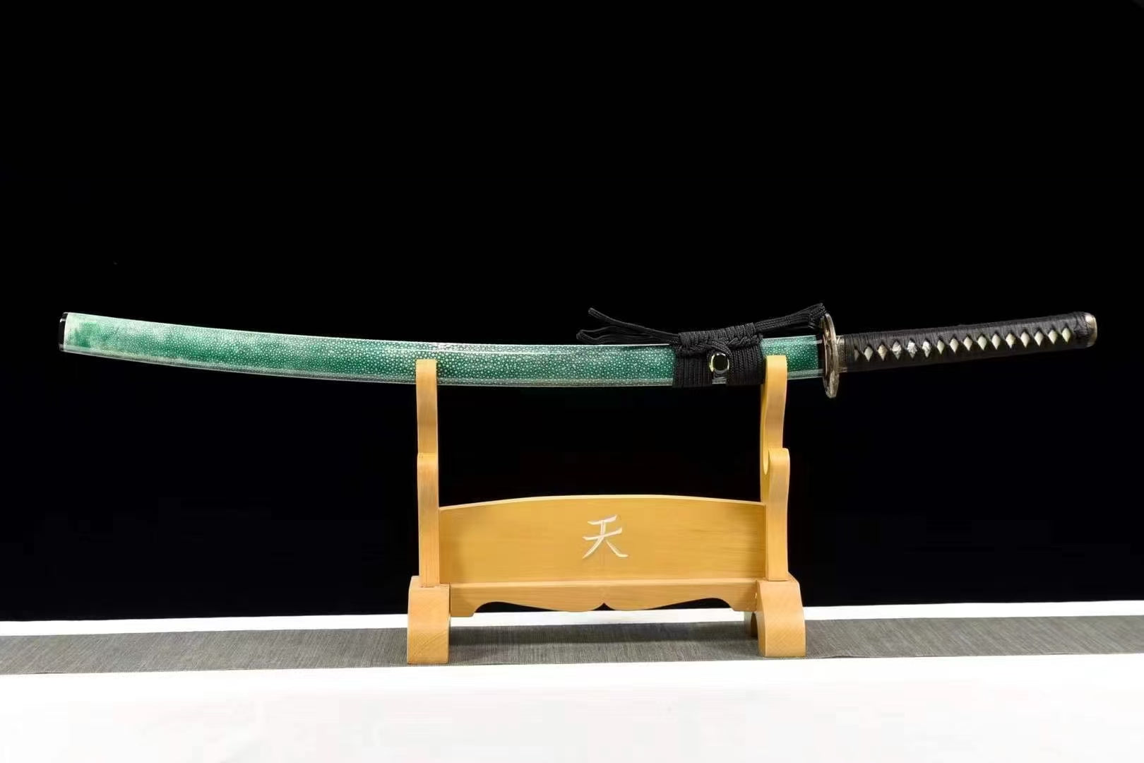 The complete Jade Tiger Katana, sheathed in its green rayskin saya, resting on a display stand.
