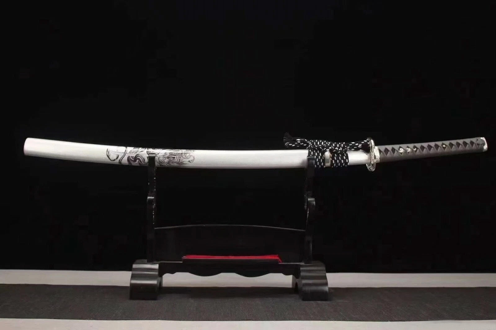 The complete Silver Dragon Katana, fully sheathed in its matte silver dragon saya, resting on a display stand.