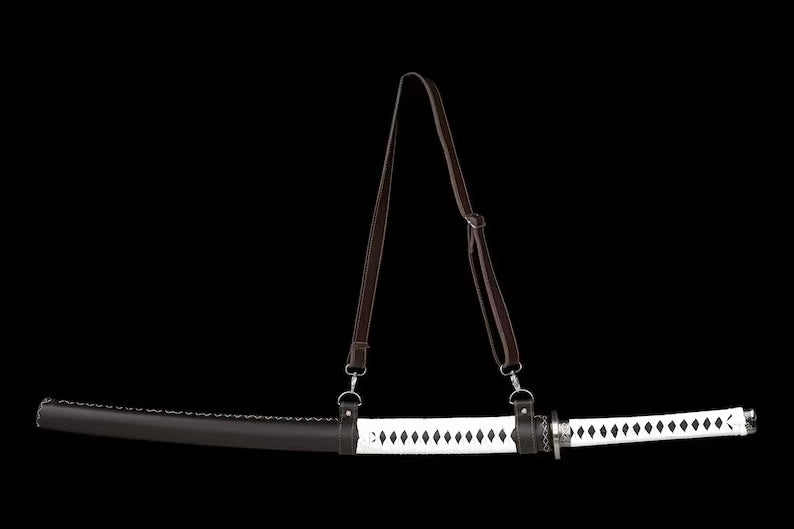 The complete replica of Michonne's katana, sheathed in its leather-wrapped saya with the full shoulder strap displayed.