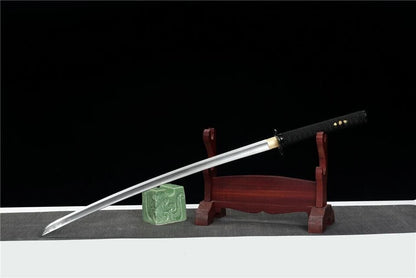 The complete Winter Plum Katana, fully sheathed in its black lacquer saya, resting on a display stand.