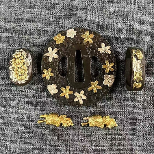 Complete Koshirae set with a Shishi (lion) and Sakura (cherry blossom) theme, featuring gilded Shishi Menuki and dual-tone gilded & silvered flowers.