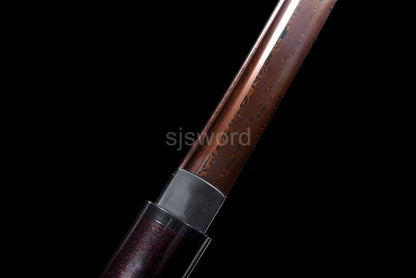 A detailed shot of the tsuka handle, highlighting the burgundy red speckled lacquer finish.