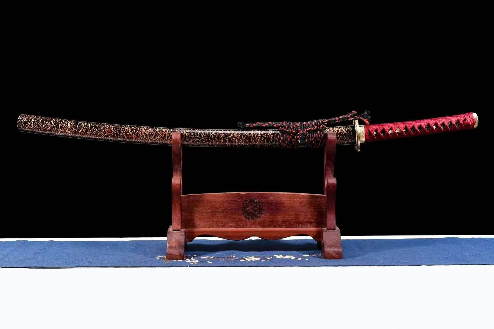 A side view of the sheathed Crimson Hitatsura Katana, highlighting the ornate koshirae.