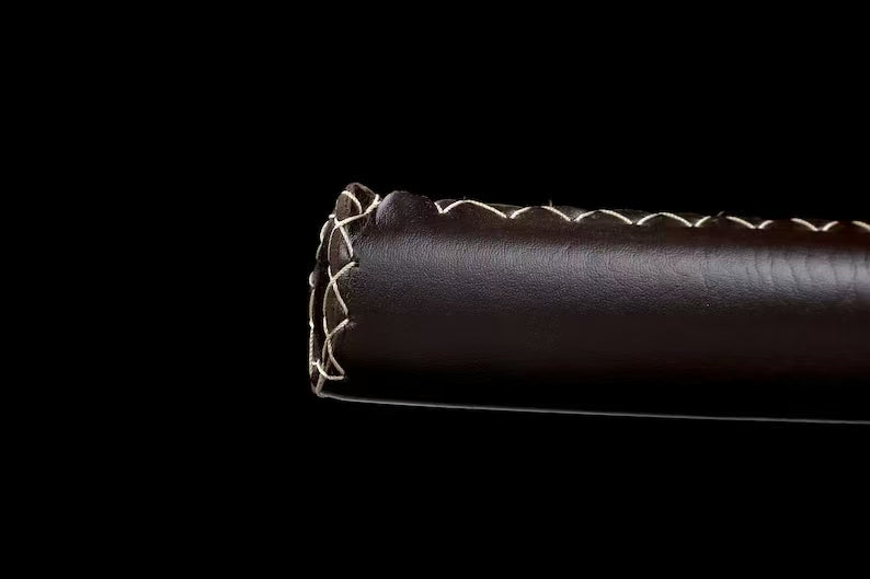 A detailed view of the brown and white stitched leather wrap on the hardwood saya of Michonne's katana.