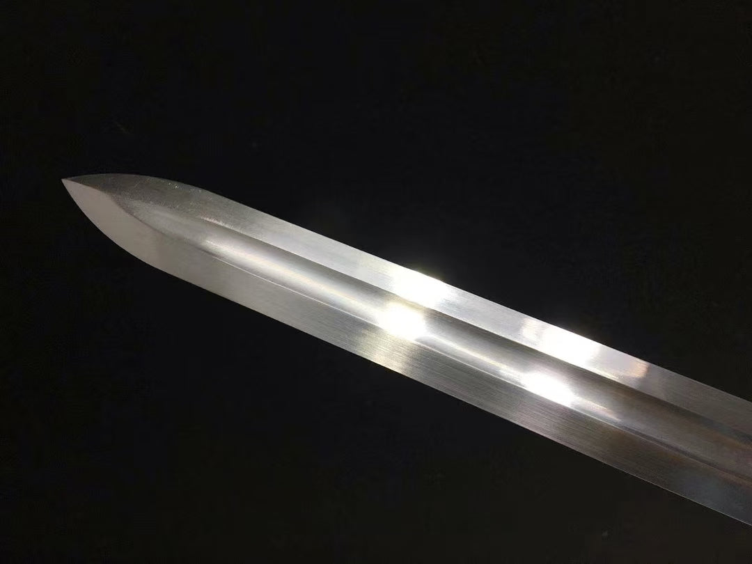A close-up of the sharp, straight-edged kissaki tip of the Green Phantom's high carbon steel blade.
