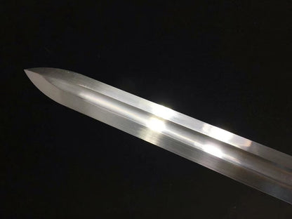 A close-up of the sharp, straight-edged kissaki tip of the Green Phantom's high carbon steel blade.