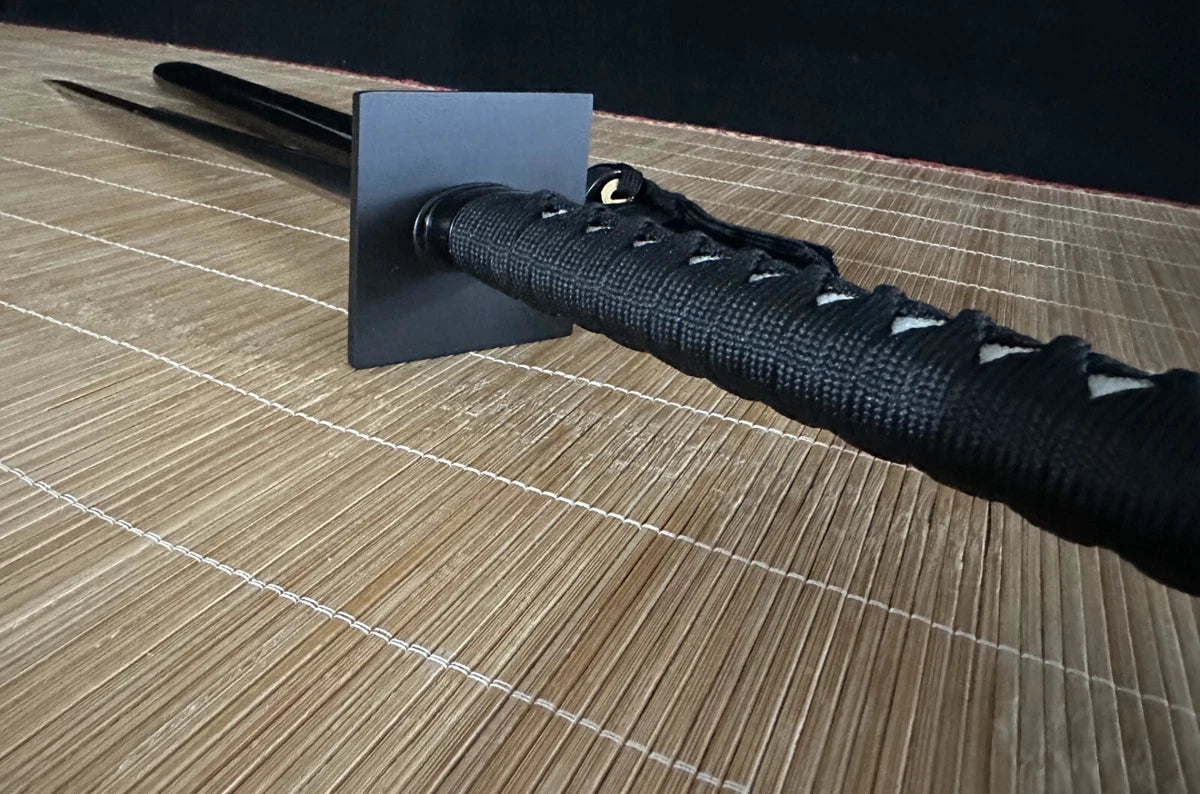 A side profile of the tsuka handle and square tsuba on the Obsidian Gale through-hardened ninja sword.