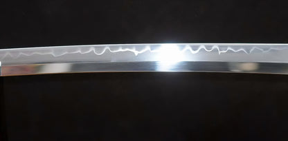 A close-up of the T10 steel blade of the Golden Hawk Katana, showing the authentic clay-tempered hamon which has been enhanced by a traditional Hadori polish.