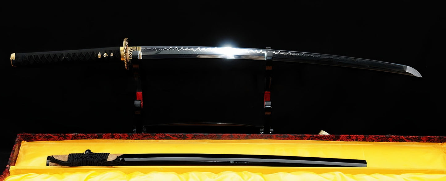 The unsheathed Golden Hawk Katana on a stand, displaying its Hadori-polished T10 blade, with the rayskin-wrapped saya below in a display box.