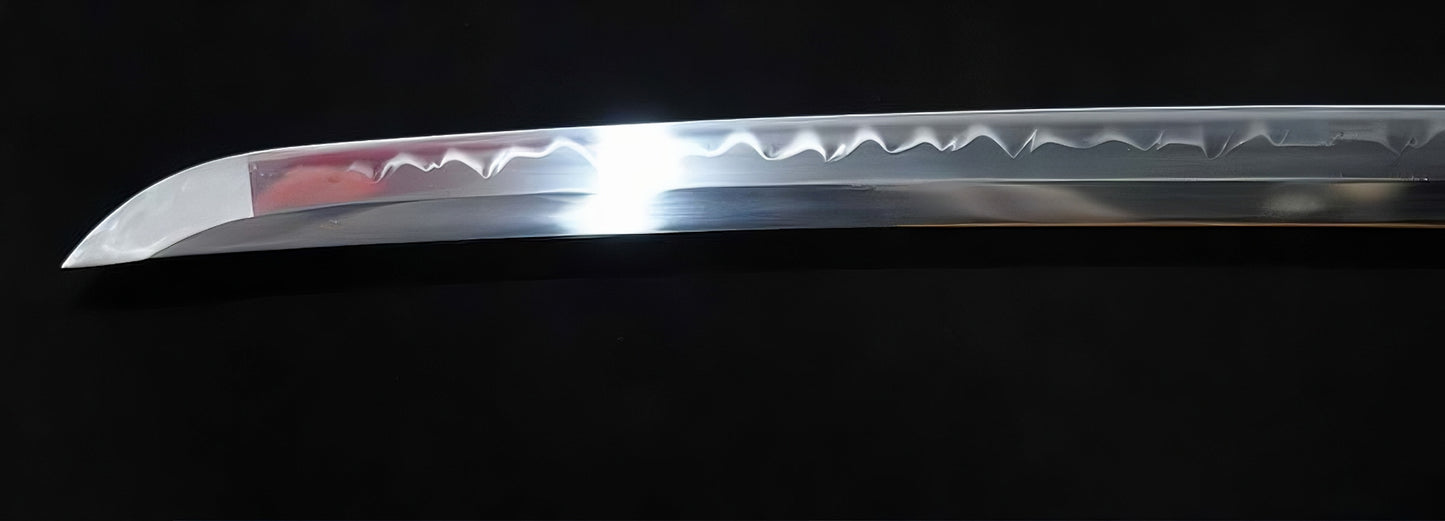 A detailed close-up of the Golden Hawk Katana's kissaki (tip), showcasing the brilliant Hadori polish on the T10 clay-tempered blade.