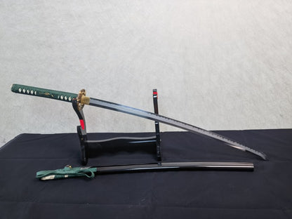 A full display view of the unsheathed Jade Serpent Katana and its half-rayskin saya on a stand.