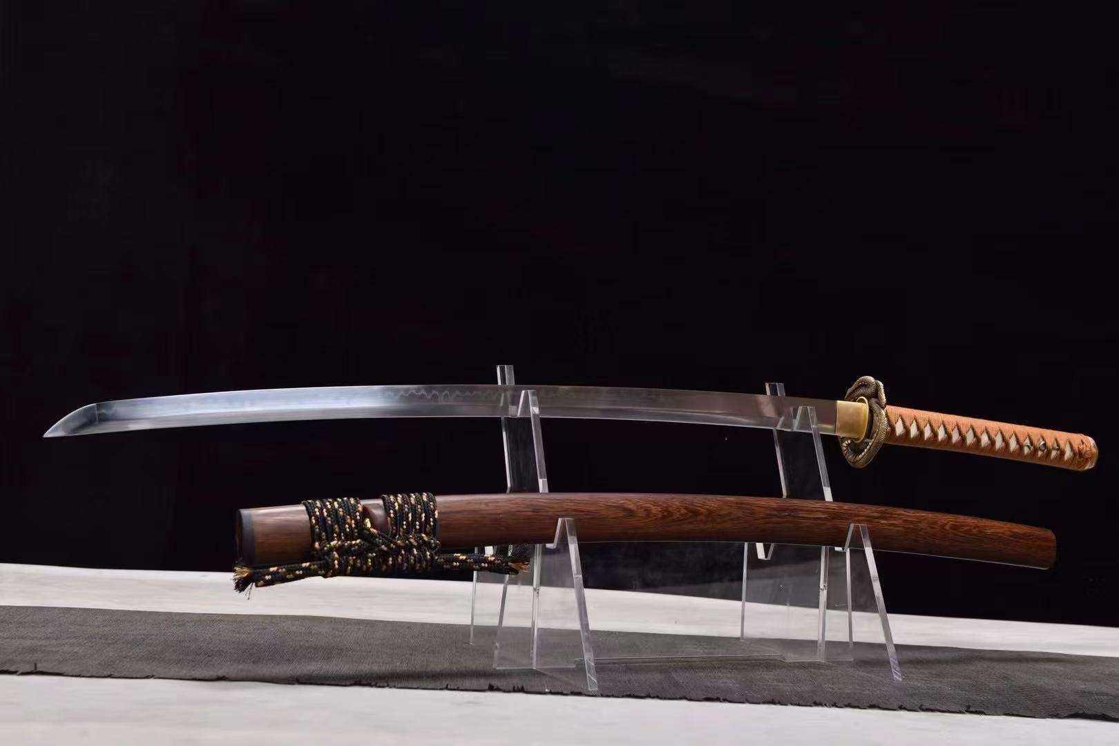 A full-length view of the unsheathed Orochi's Coil Katana, showcasing its T10 steel blade and rosewood saya.