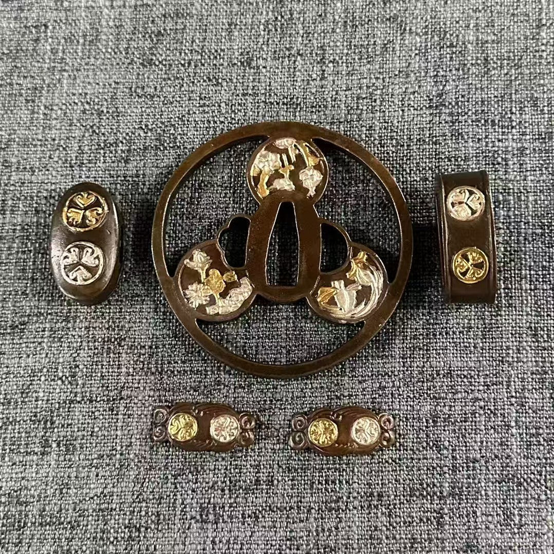 Complete Koshirae set with a Mitsu Tomoe Sukashi Tsuba, featuring gold and silver gilded floral details on all components.