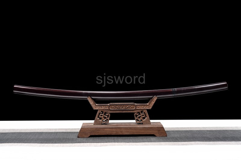 An alternate angle of the unsheathed shirasaya, displaying the full red folded steel blade and its saya.