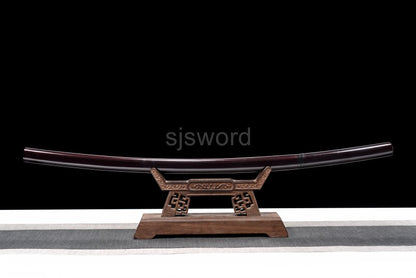 An alternate angle of the unsheathed shirasaya, displaying the full red folded steel blade and its saya.