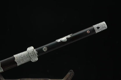 A close-up of the General's Virtue Dao's hilt, showcasing the full ebony handle, white copper guard, and matching fittings on the ebony scabbard.