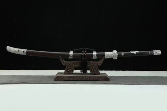 The General's Virtue Dao, showcasing its full length, the complete ebony scabbard, and its intricate white copper (Bai Tong) fittings on a display stand.