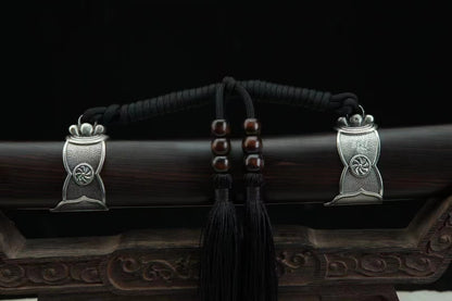 A detailed view of the General's Virtue Dao's suspension mounts, showcasing the white copper (Bai Tong) fittings, the black silk tassel (Sui), and the dark ebony scabbard.