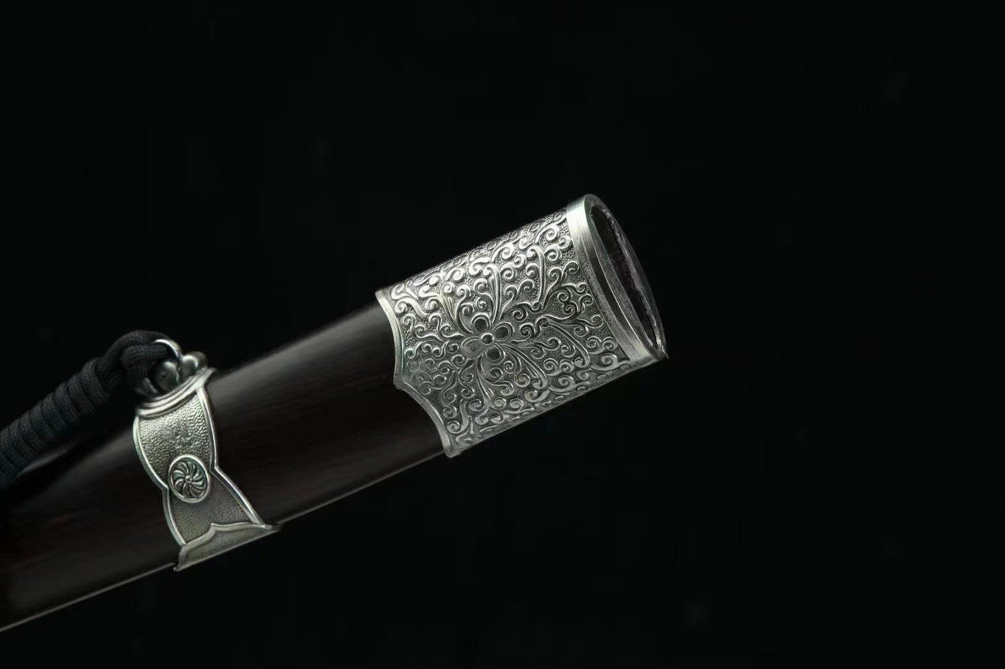 A close-up of the General's Virtue Dao's scabbard mouth, highlighting the detailed white copper (Bai Tong) fitting and the genuine ebony wood.