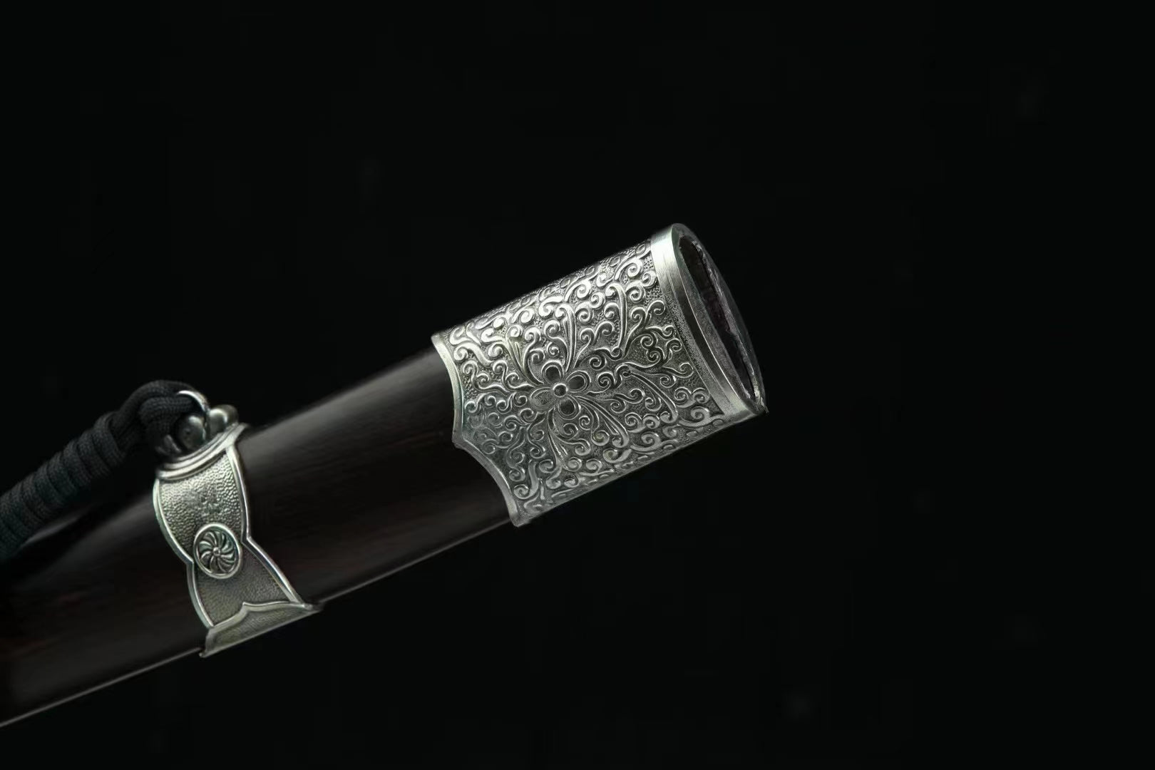 A close-up of the General's Virtue Dao's scabbard mouth, highlighting the detailed white copper (Bai Tong) fitting and the genuine ebony wood.